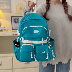 Japanese style teal school backpack with multi-pocket design and plush charm pendant