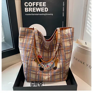 Close-up of checkered tote bag with 3D plush dachshund embroidery in a gift display box