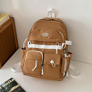 Brown multi-pocket large capacity nylon backpack with white contrast straps and logo tag