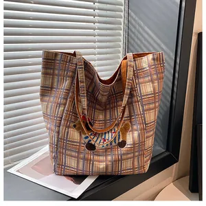 Close-up of a large checkered canvas tote bag with a cute dachshund embroidery patch