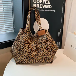 Retro leopard print tote bag with leather tag on a cafe table, chic large shoulder bag