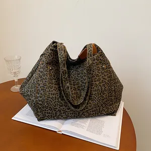 Fashionable leopard print canvas tote bag with large front pocket and silver metal rivets