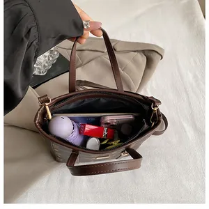 Interior view of brown patterned bucket bag showing capacity for umbrella and cosmetics