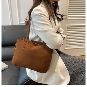 Brown retro shoulder bag in matte texture shown on model for daily commuting fashion