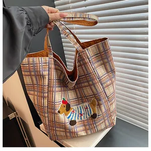 Detailed view of canvas tote bag with a cute 3D cartoon dog patch and plaid pattern