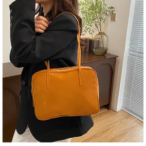 Ginger yellow square tote bag worn with black blazer for a retro commute style