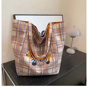 Detail of checkered canvas tote bag with 3D dachshund patch embroidery and long handles