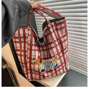 Detail of red and green plaid tote bag featuring a cute 3D puppy embroidery patch