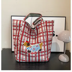 Detail of red and white checkered canvas tote bag with a cute dachshund embroidery patch
