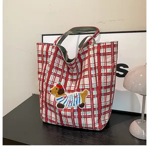 Detailed view of red checkered tote bag featuring a cute dachshund puppy embroidery patch