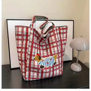Detail of red checkered canvas tote bag with cute cartoon dachshund embroidery patch