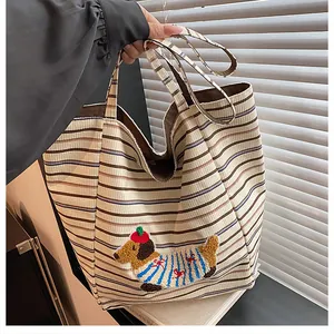 Detail of corduroy tote bag with cute dachshund embroidery and brown striped pattern