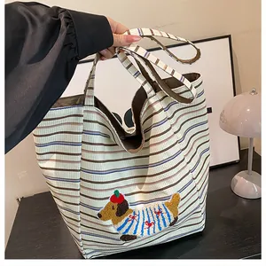 Detail of canvas tote bag showing striped pattern and cute dachshund patch embroidery