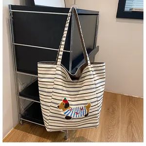 Detailed view of striped corduroy tote bag featuring a 3D cute dachshund plush embroidery