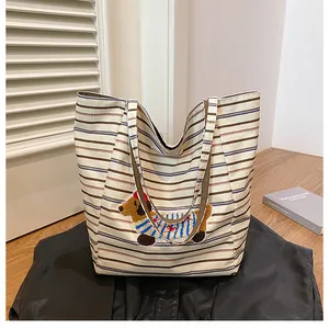 Detail of cute stripe canvas tote bag with 3D cartoon dachshund embroidery patch