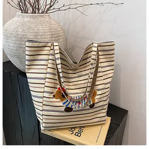 Detailed view of striped canvas tote bag featuring 3D dachshund embroidery patch