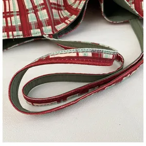 Detailed macro view of red and green checkered corduroy tote bag with green lining