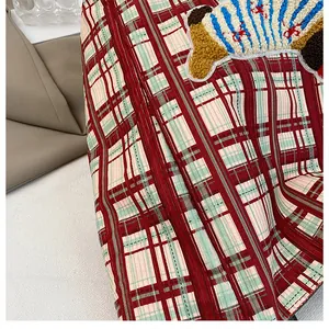 Detail of red and green plaid canvas tote with a textured blue 3D towel embroidery patch