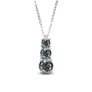 Macro detail of three-stone Moissanite pendant vertically set on a silver chain