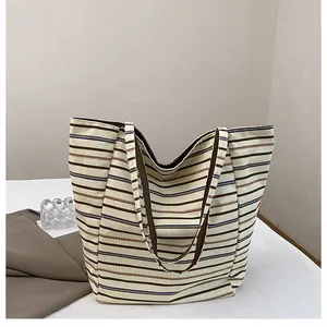 Detail view of the soft corduroy fabric and retro striped pattern on this tote bag