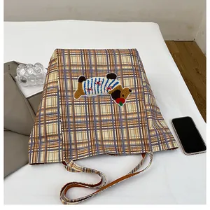 Detailed view of yellow plaid canvas tote with a cute cartoon puppy embroidery patch