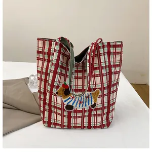 Detail of red and green plaid canvas tote bag with 3D dachshund embroidery patch