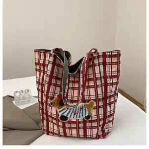 Detail of red and green plaid canvas tote with a cute dachshund embroidery patch