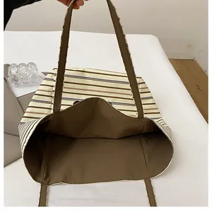Close-up of the striped canvas tote bag interior showing spacious capacity and dark lining