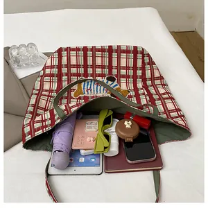 Top view of large plaid tote bag interior showing ample space for daily essentials