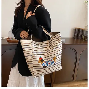 Detail of cute dachshund embroidery on canvas tote bag with striped pattern