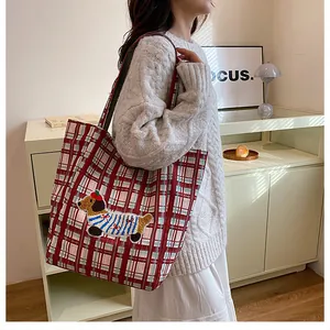 Detail of red checkered canvas tote bag with cute dachshund embroidery and large capacity