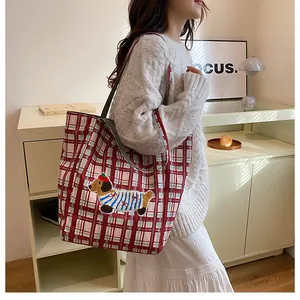 Detail of red and blue checkered canvas tote bag with 3D dachshund embroidery applique