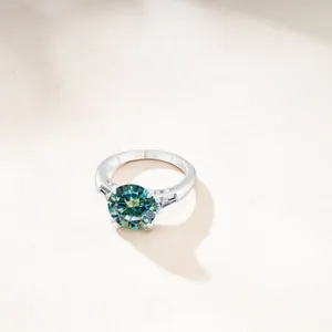 Luxurious S925 sterling silver ring featuring a 6.5ct round teal moissanite with side stones