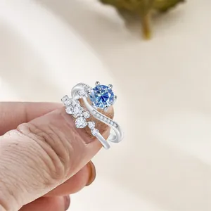 Detail of S925 sterling silver stamp on blue moissanite double ring stack set