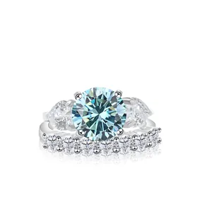 Luxurious 12ct blue moissanite set with pear side stones and half-eternity band