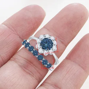 Macro shot of S925 silver ring set featuring a 1ct blue moissanite halo and wedding band