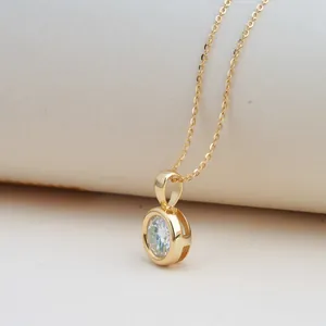 Detail of a 2-carat Moissanite necklace with a gold-plated silver bezel-set pendant