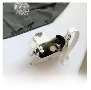 Interior view of white crescent shoulder bag showing space for phone and makeup
