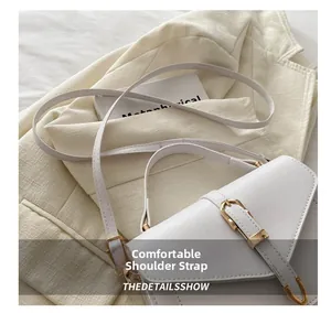 Detail showing the comfortable white leather shoulder strap and golden U-shaped metal buckle