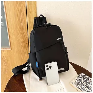 Détail du sac à bandoulière SORAKA noir montrant la texture et la taille avec un téléphone
