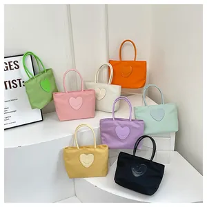 Detailed collection of small nylon tote bags in eight vibrant colors with heart smile patches