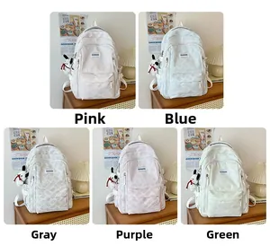 Detail of multi-color fabric backpacks with plush puppy charms in cozy interior settings