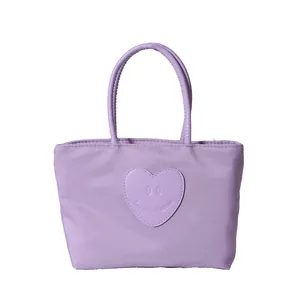 Light purple nylon tote bag with heart-shaped patch and round double handles