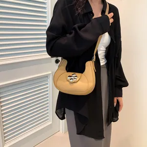 Chic khaki crescent underarm bag with silver flower buckle shown on female model
