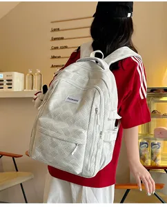 Detail of white textured fabric backpack with woven pattern and side adjustable straps