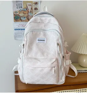Detail view of the fabric texture and brand label on a multi-pocket casual backpack