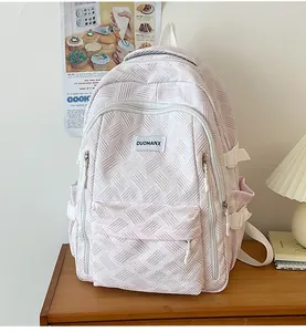 Close-up of pink casual backpack with quilted texture and side adjustment straps