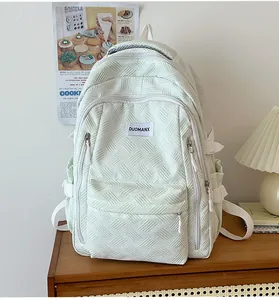 Detail of mint green backpack with embossed texture on vintage wooden furniture