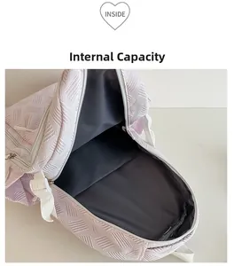 Detail of spacious main compartment showing internal capacity of the pink backpack