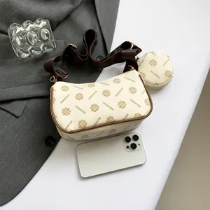 Detail of cream shoulder bag with brown strap and matching round coin purse